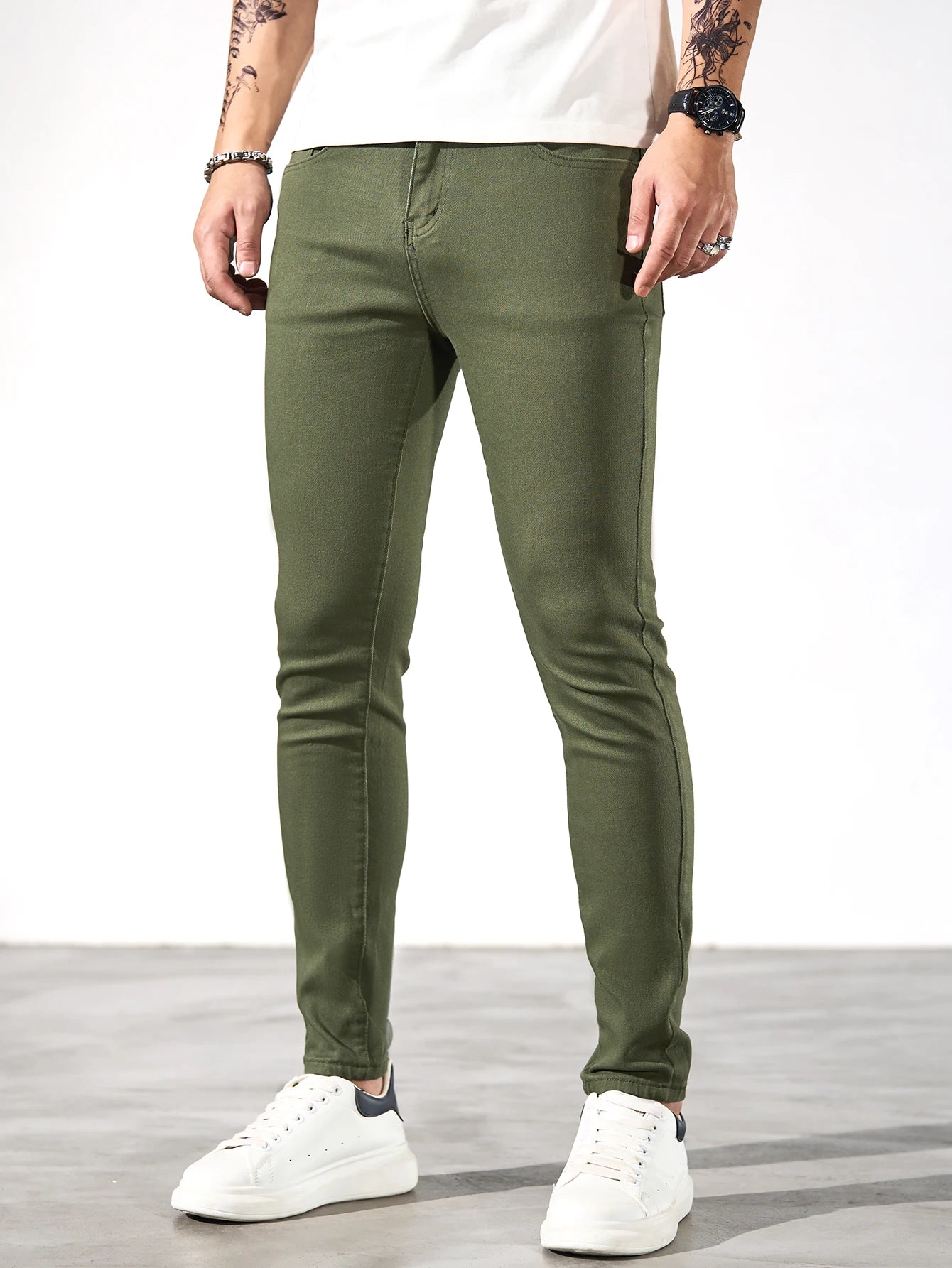 Fashionable men's skinny jeans. Army green straight skinny trousers. Casual street men's jeans.