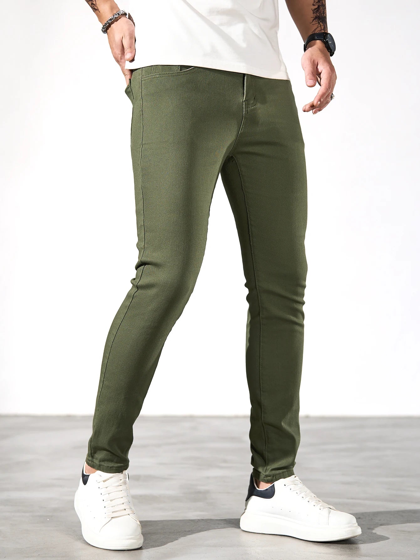 Fashionable men's skinny jeans. Army green straight skinny trousers. Casual street men's jeans.