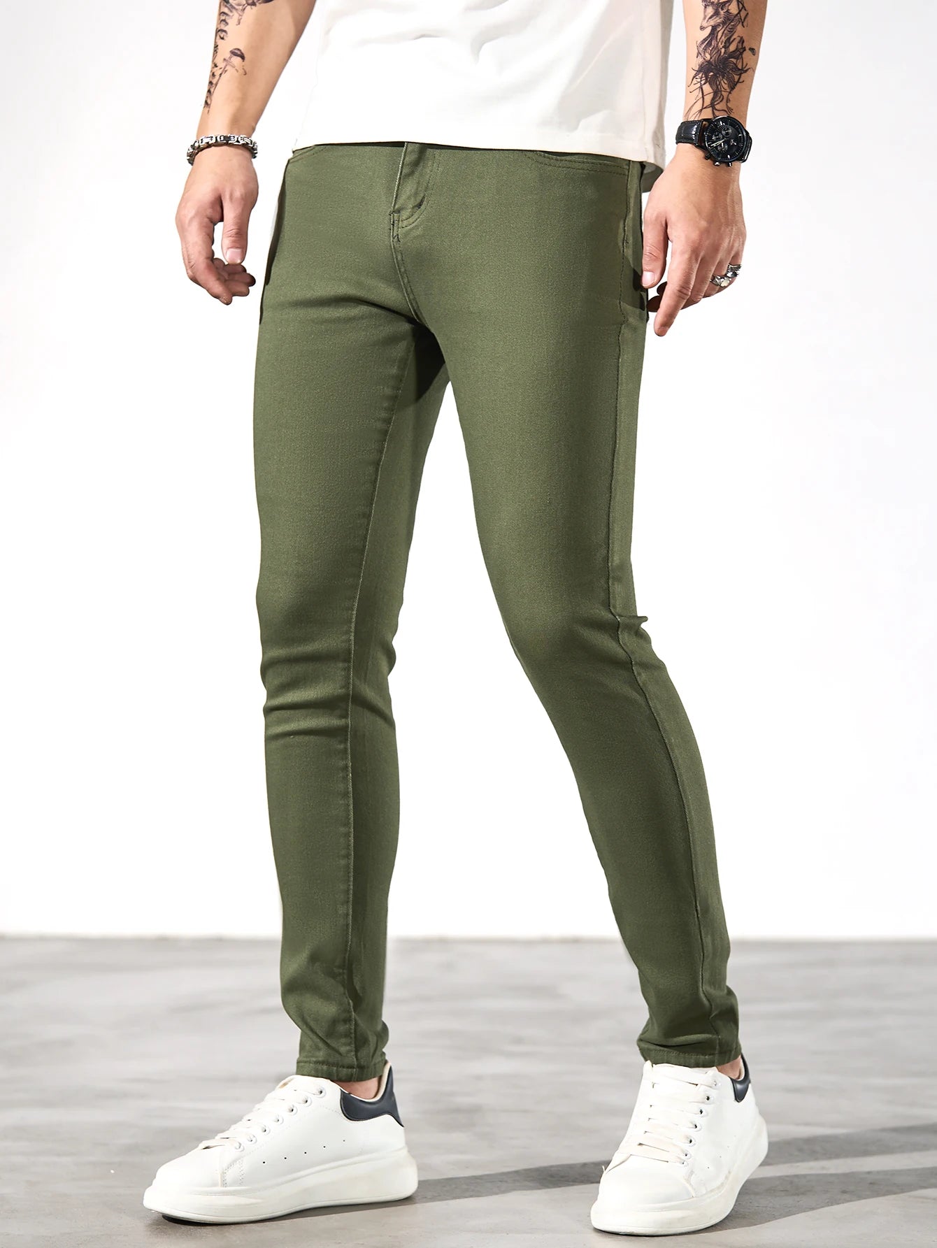 Fashionable men's skinny jeans. Army green straight skinny trousers. Casual street men's jeans.