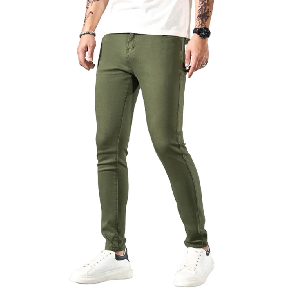 Fashionable men's skinny jeans. Army green straight skinny trousers. Casual street men's jeans.